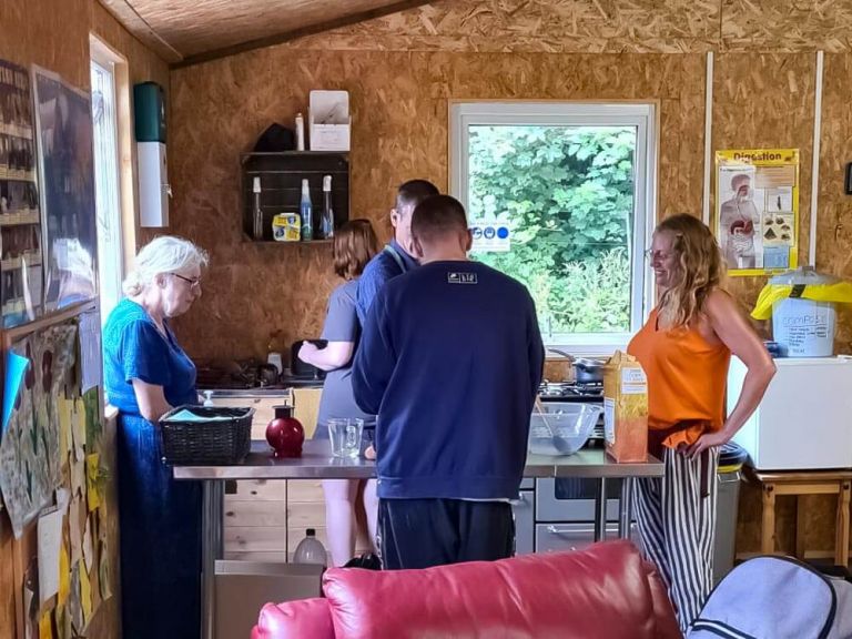 Group of adults leaning how to cook together.
