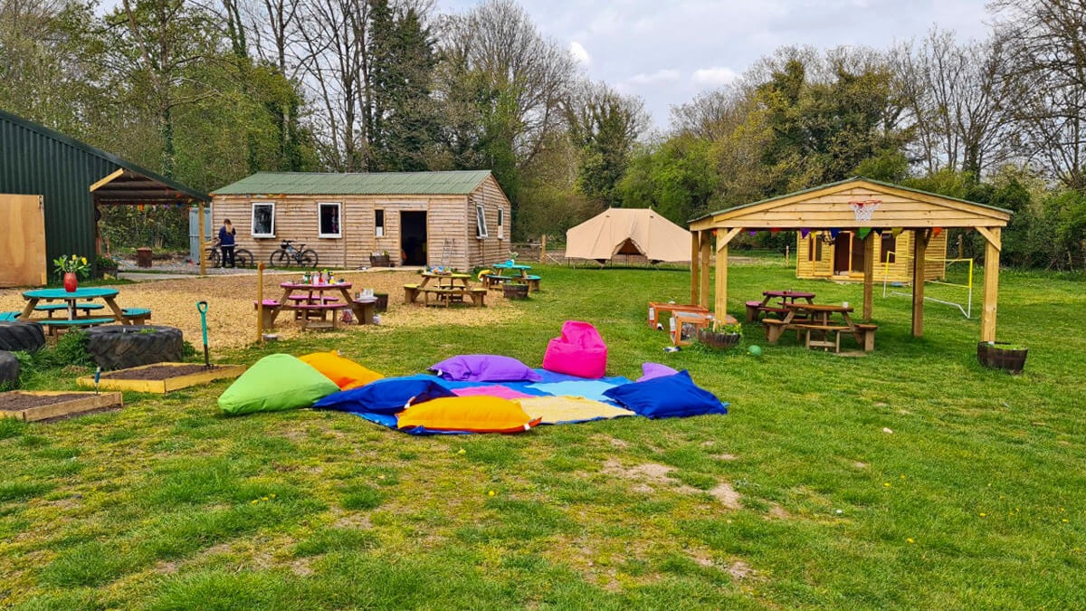 Woodstock community completed with wooden buildings and outdoor seating area.